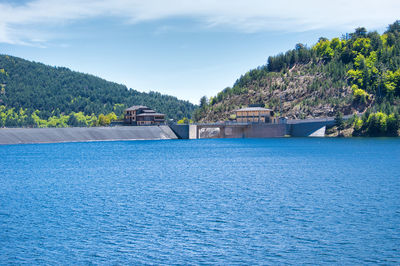 Scenic view of swimming pool by sea against sky