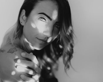 Close-up portrait of a beautiful young woman over white background