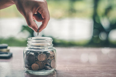 Close-up of hand holding glass jar