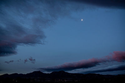 Scenic view of mountains against sky at night