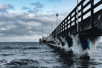 Pier over sea against sky