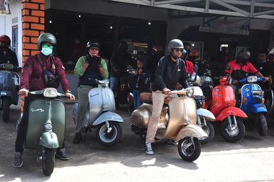 People sitting on motor scooter