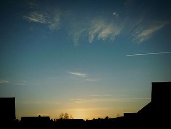 Low angle view of silhouette built structure against sky at sunset