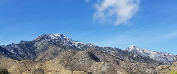 Low angle view of mountain against blue sky