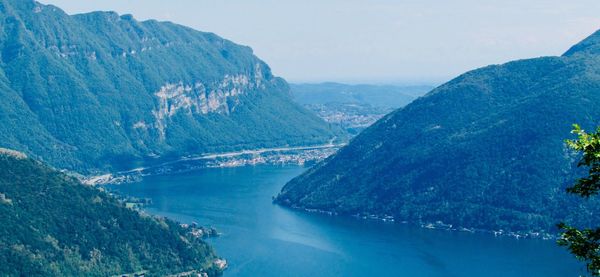 Aerial view of river amidst mountains against sky