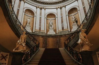 Low angle view of sculptures on staircase in building