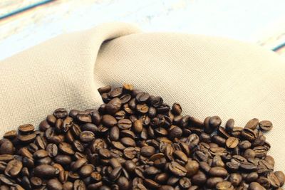 High angle view of coffee beans with napkin on table