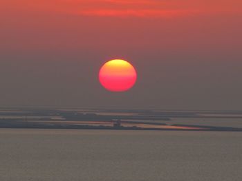 Scenic view of ball against sky during sunset