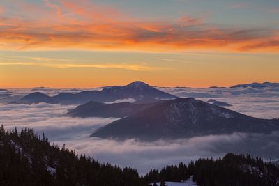 Scenic view of snowcapped mountains against sky during sunset