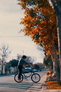 Woman with her bicycle in the street