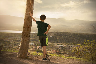 Man standing on mountain against sky