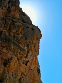 Low angle view of rock formation against clear blue sky