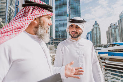 Business people discussing while standing in city