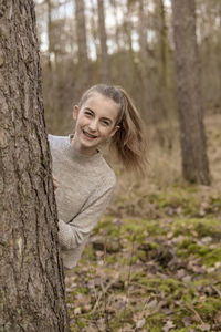 Portrait of a smiling young woman in forest