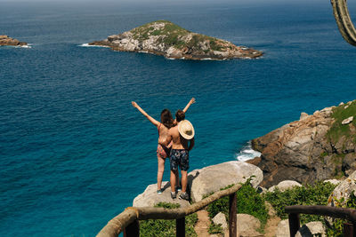 Couple standing against sea