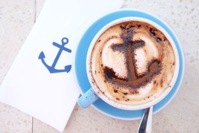 Close-up of coffee cup with anchor froth