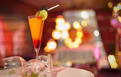 Cocktail served on table in illuminated restaurant