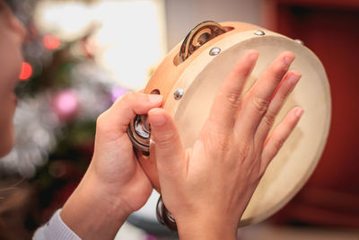 Cropped hands of woman playing musical instrument