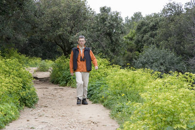 Full length of man on walkway amidst plants