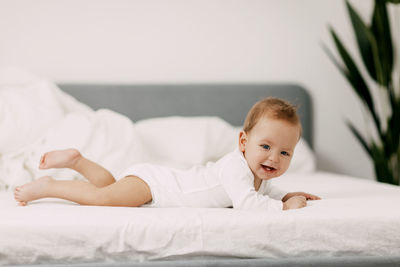 Cute baby lying on bed at home