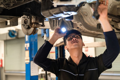 Portrait of young man working in factory