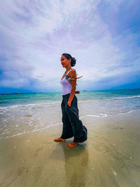 Full length of beautiful thai woman on beach