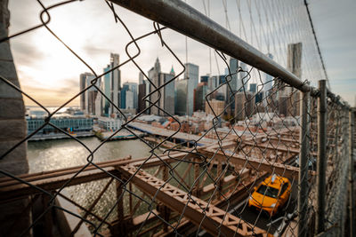 New york city skyline from brooklyn bridge,framed by fens