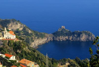 High angle view of townscape by sea against sky