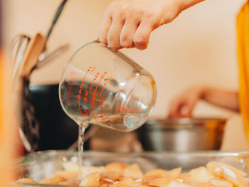 Close-up of hand pouring wine in glass