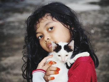 Girl holding kitten