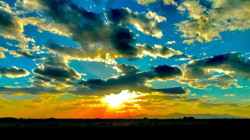 Scenic view of silhouette landscape against sky at sunset
