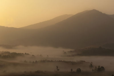 Scenic view of mountains against sky during foggy weather