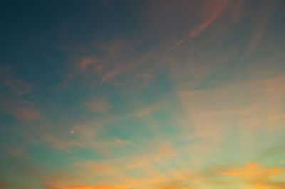 Low angle view of cloudy sky at sunset