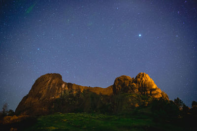 Scenic view of mountains against sky at night