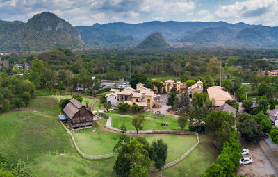 High angle view of houses on field against buildings