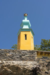 Low angle view of building against clear blue sky