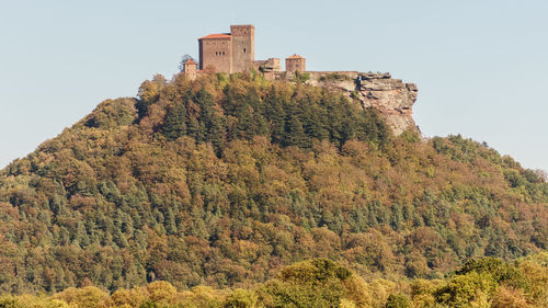 Low angle view of castle on mountain against sky