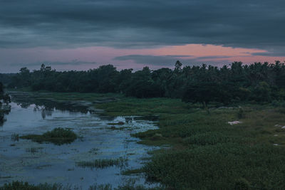 Scenic view of lake against sky during sunset