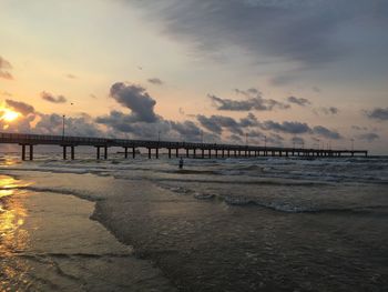 Scenic view of beach against sky during sunset