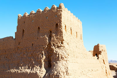 Low angle view of historical building against clear blue sky