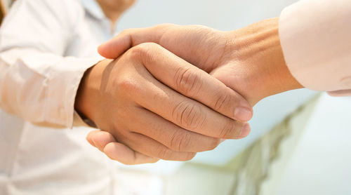 Midsection of couple holding hands