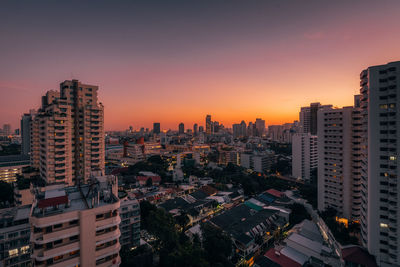 High angle view of buildings in city against sky during sunset