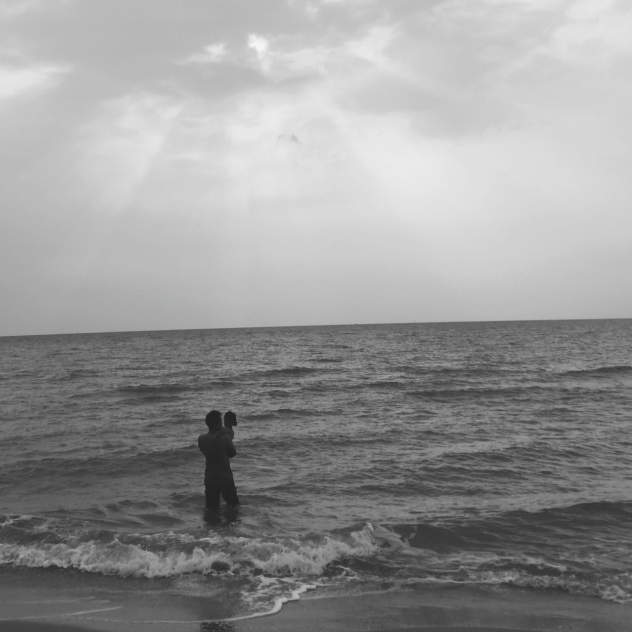 sea, horizon over water, water, sky, leisure activity, lifestyles, scenics, beach, beauty in nature, tranquil scene, men, tranquility, rear view, standing, nature, waterfront, wave, idyllic