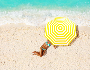 High angle view of umbrella on sand at beach