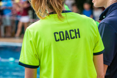 Rear view of man and woman standing on soccer field