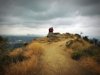 Rear view of couple overlooking landscape