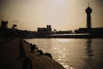 View of calm river with buildings in background