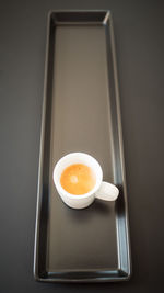 High angle view of coffee cup over black background