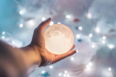 Close-up of hand holding crystal ball