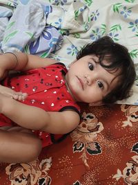 Portrait of cute girl lying on bed